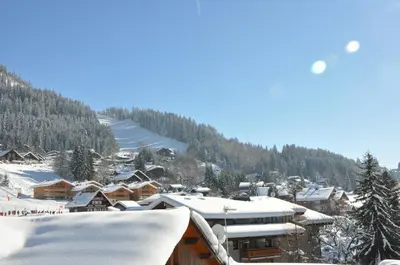 a town covered in snow with a mountain in the background at SL127 - 2 Pièces 4 Pers centre Carroz in Les Carroz d'Araches