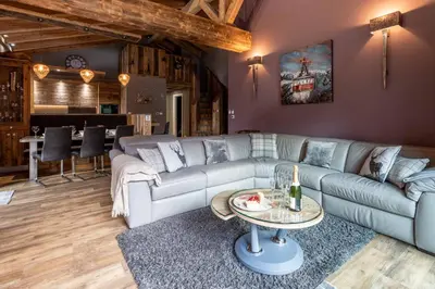 a living room with a couch and a table at Chalet des Amis- Chamonix All Year in Chamonix-Mont-Blanc