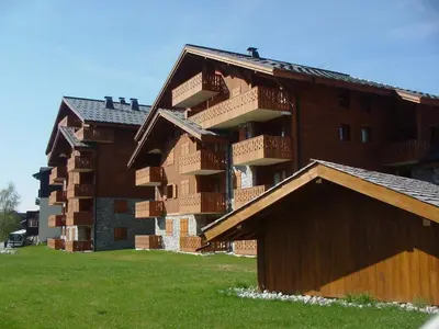 a building with balconies on the side of it at Appartement 3 Pièces 6 Pers avec Balcon aux Carroz - FR-1-572-53 in Les Carroz d'Araches