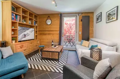 a living room with two couches and a tv at Le Paradis 25 Apartment - Chamonix All Year in Chamonix-Mont-Blanc
