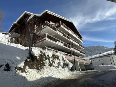 a building on top of a snow covered hill at Appartement Central 6 Pers, Parking, Ascenseur, Proche Pistes et Commerces - FR-1-572-22 in Les Carroz d'Araches