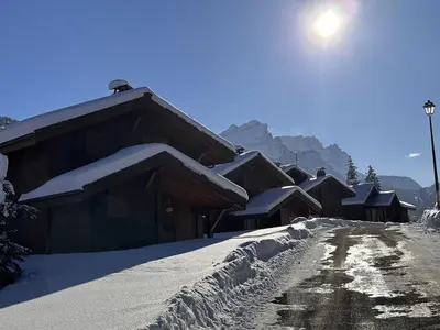 a row of houses covered in snow on a mountain at Duplex chaleureux 4 pièces avec wifi, parking, proche spa & bus pour ski - FR-1-572-43 in Les Carroz d'Araches