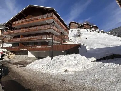 a building with a pile of snow in front of it at Appartement cosy 4 pièces, 8 pers, garage, proche pistes et commerces - FR-1-572-73 in Les Carroz d'Araches