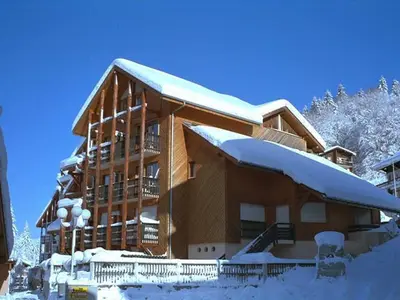 a large building with snow on the roof at Studio chaleureux 4 pers, centre village, proche pistes et commerces, balcon sud-ouest - FR-1-572-105 in Les Carroz d'Araches