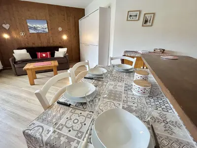 a kitchen and living room with a table and chairs at Studio avec Piscine Chauffée, Tennis & Balcon - 4 Couchages à Megève - FR-1-597-14 in Megève