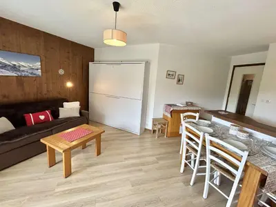 a living room with a couch and a table at Studio avec Piscine Chauffée, Tennis & Balcon - 4 Couchages à Megève - FR-1-597-14 in Megève