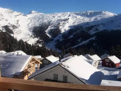 a town with snow covered roofs and mountains at Résidence Chateaux De Crans - Appartement confortable · Balcon MAE-7375 in Flaine