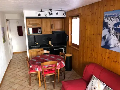 a kitchen with a table and chairs and a kitchen with a table and a kitchen at Petite Marmotte in Saint-Gervais-les-Bains