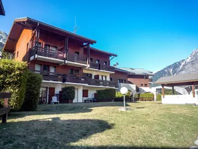 a large apartment building with a yard in front of it at Studio Les Jardins du Mont-Blanc-4 by Interhome in Chamonix-Mont-Blanc
