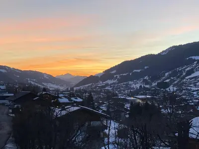 a view of a city in the snow at sunset at CHALET 