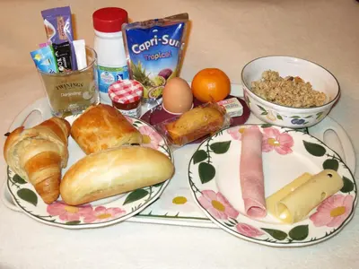 a table with two plates of bread and other food at Grey Squirrel Home in Chamonix-Mont-Blanc