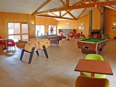a large room with several tables and pool tables at Appartement cosy 2-4 pers avec terrasse et parking - FR-1-629-32 in Samoëns