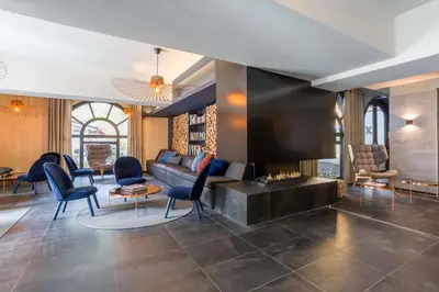 a living room with a couch and a fireplace at La Cordee 703 Apartment - Chamonix All Year in Chamonix-Mont-Blanc