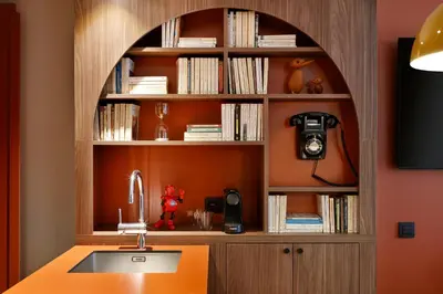 a kitchen with a sink and a book shelf at RockyPop Flaine Hotel & Spa in Flaine