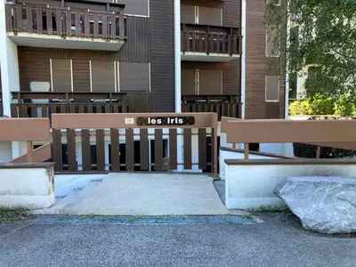 two park benches sitting in front of a building at Studio moderne avec balcon et parking dans Samoëns - FR-1-624-71 in Samoëns