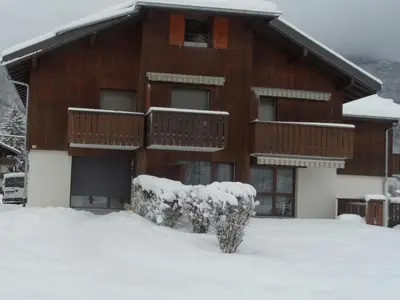 a building with snow on the ground in front of it at Studio coquet avec terrasse, calme et parking à Samoëns - FR-1-629-86 in Samoëns