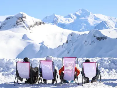 a group of people sitting in chairs in the snow at Confortable appartement 3 chambres avec WiFi pour 8 personnes - FR-1-642-7 in Morillon