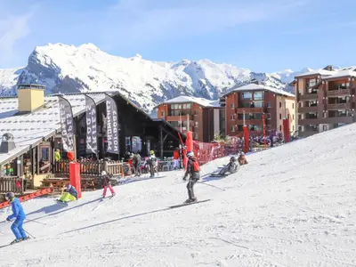 a group of people skiing down a snow covered slope at Appartement confortable 6 pers au pied des pistes à Morillon - FR-1-642-37 in Morillon