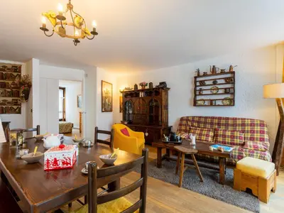 a living room with a couch and a table at Apartment Le Beau Site by Interhome in Chamonix-Mont-Blanc