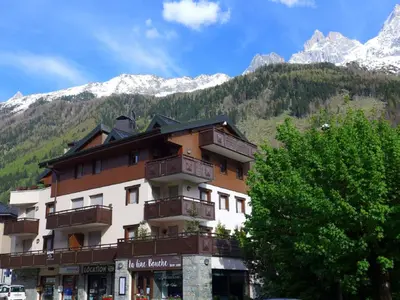a building with balconies in front of a mountain at Apartment L'Espace Montagne-17 by Interhome in Chamonix-Mont-Blanc