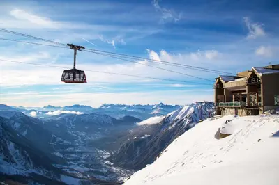 a ski lift on top of a snow covered mountain at La Maisonnée de Julie - Happy Rentals in Chamonix-Mont-Blanc