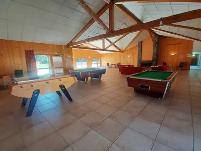 a large room with two pool tables and couches at Appartement familial avec piscines à Samoëns - FR-1-624-103 in Samoëns