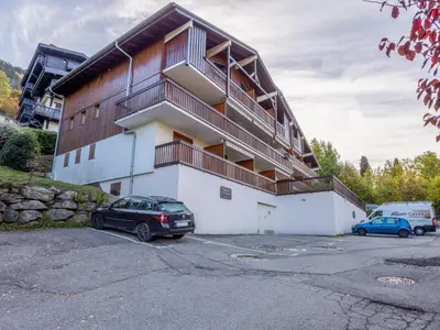 a building with a car parked in a parking lot at Apartment Le Martagon 007 by Interhome in Saint-Gervais-les-Bains