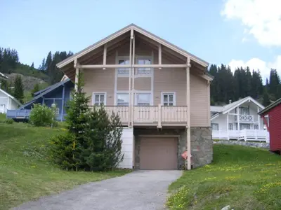 a large house with a porch and a garage at Chalet lumineux avec poêle à bois et WIFI gratuit - 6 à 8 personnes - Garage - FR-1-425-117 in Flaine