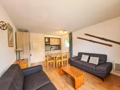 a living room with a couch and a table at Appartement confortable au centre, balcon, 6 personnes - FR-1-425-142 in Flaine