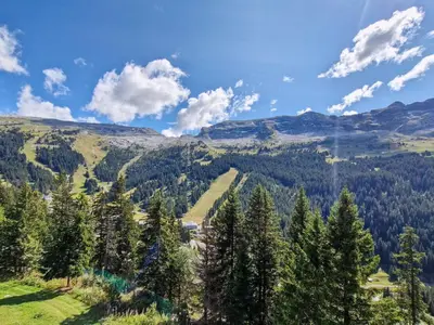 a view of a snow covered mountain with trees and icicles at Appartement lumineux au centre avec balcon et parking - FR-1-425-177 in Flaine