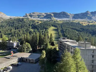 a person standing in a parking lot in front of a mountain at Studio lumineux proche des pistes avec balcon - FR-1-425-169 in Arâches-la-Frasse