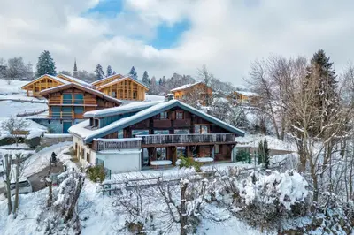 a log home in the snow with snow covered trees at Appartement Alpage - Welkeys in Combloux