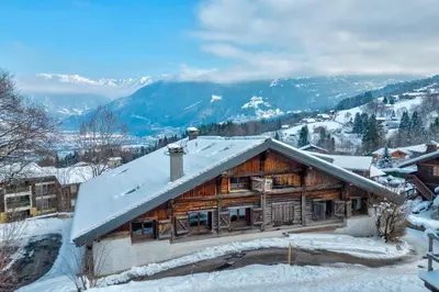 a log cabin with snow on the roof at Appartement Le Mont-Blanc - Welkeys in Combloux