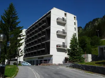 a large white building on the side of a road at Studio lumineux avec balcon et casier à ski proche des pistes - FR-1-425-185 in Arâches-la-Frasse