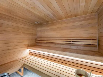 a sauna with wooden paneling on the wall at Appartement de Standing à Megève, 5 Min des Pistes, Sauna, Hammam, Parking, Animaux Acceptés - FR-1-569-52 in Megève
