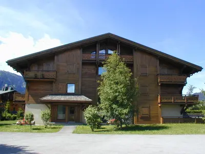 a large wooden house with a tree in front of it at Charmant appartement 2 chambres à Megève avec Wifi et parking - FR-1-453-292 in Megève