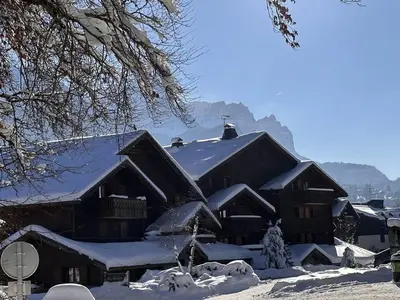a large building covered in snow with snow at Appartement 3 pièces pour 6 pers, bien équipé, face au spa et ski bus, proche pistes et commerces - FR-1-572-10 in Arâches-la-Frasse