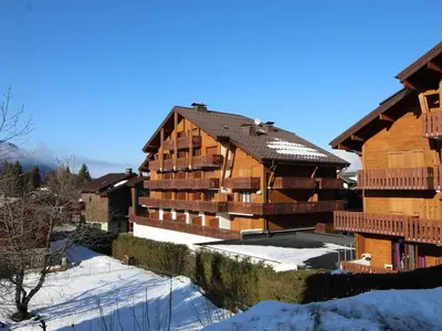 a large wooden building with snow on the ground at Duplex moderne 3 pièces proche des pistes, 8 pers. - FR-1-572-71 in Arâches-la-Frasse