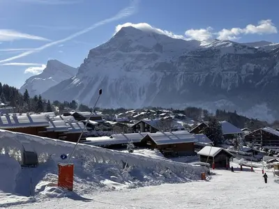 a ski resort with a snow covered mountain in the background at Appartement cosy 4 pers au pied des pistes avec parking, balcon, lave-vaisselle et services additionnels - FR-1-572-87 in Arâches-la-Frasse