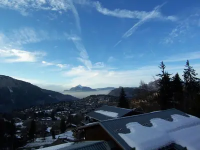 a view of a city in the mountains with snow at Studio 4 pers. avec lave-linge, balcon et accès direct aux pistes - Proche centre des Carroz - FR-1-572-176 in Arâches-la-Frasse