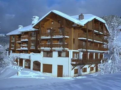 a large building with snow on top of it at Studio charmant 4 pers, centre village, proche pistes et commerces - FR-1-572-122 in Arâches-la-Frasse