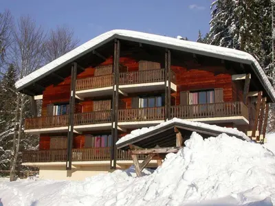a log cabin in the snow with a pile of snow at Studio 4 pers, rénove, lave-vaisselle, parking, pied des pistes - FR-1-572-197 in Arâches-la-Frasse