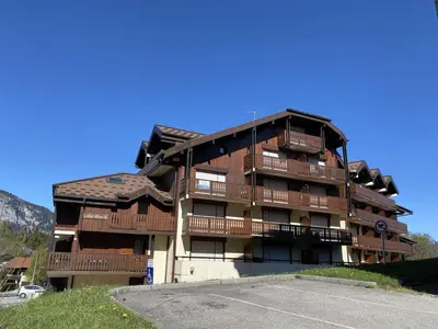 a apartment building with balconies and a parking lot at Studio rénové pour 4 personnes, centre station, proche pistes et commodités - FR-1-572-24 in Arâches-la-Frasse