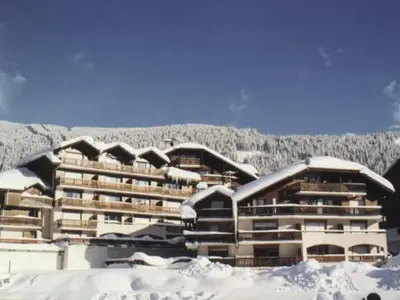 a large building with snow on the roof at Studio rénové pour 4 personnes, centre station, proche pistes et commodités - FR-1-572-24 in Arâches-la-Frasse
