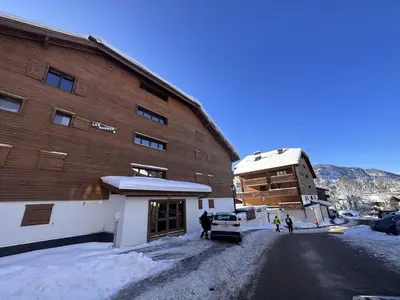 a large building with snow on the ground next to it at Studio spacieux 4 pers avec garage, lave-vaisselle aux Carroz - FR-1-572-159 in Arâches-la-Frasse
