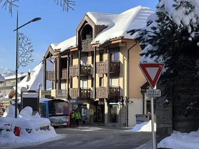 a large building with snow on the top of it at Studio central village aux Carroz, animaux admis, 5 pers - FR-1-572-202 in Arâches-la-Frasse