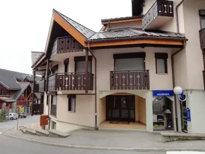a building with balconies on the side of a street at Studio central village aux Carroz, animaux admis, 5 pers - FR-1-572-202 in Arâches-la-Frasse