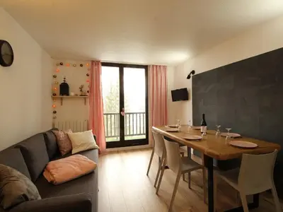 a living room with a table and a couch at Appartement rénové 3 pièces - 6 pers - Balcon Sud - Résidence Sirius à Flaine Forêt - FR-1-687-5 in Arâches-la-Frasse