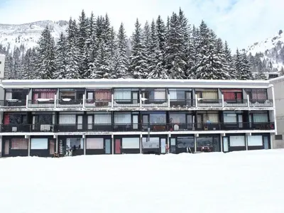 a building in the snow with snow covered trees at Studio pour 4 personnes, résidence Bellatrix, Flaine Front de Neige, accès direct aux pistes - FR-1-687-45 in Arâches-la-Frasse