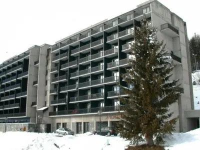 a large building with a christmas tree in front of it at Studio rénové 4 pers avec balcon sud, proche pistes et commerces, casier à skis, parking - FR-1-687-33 in Arâches-la-Frasse